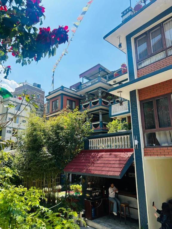 Garden cafe and sitting nook at Boudha Orange Hotel surrounded by greenery